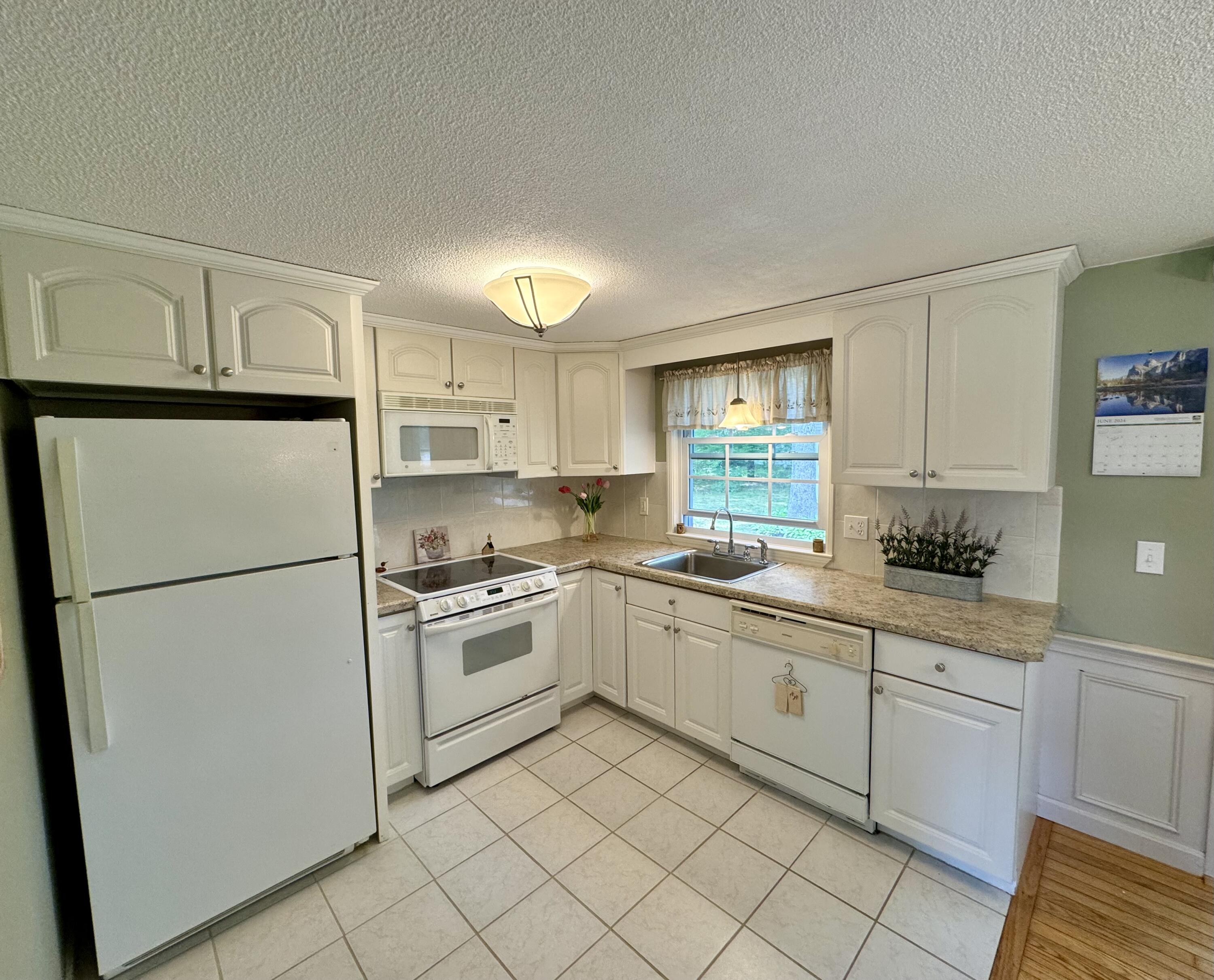 173 Nottingham Drive Centerville, MA 02632 - Photo 15 of 54 a kitchen with white cabinets and white appliances