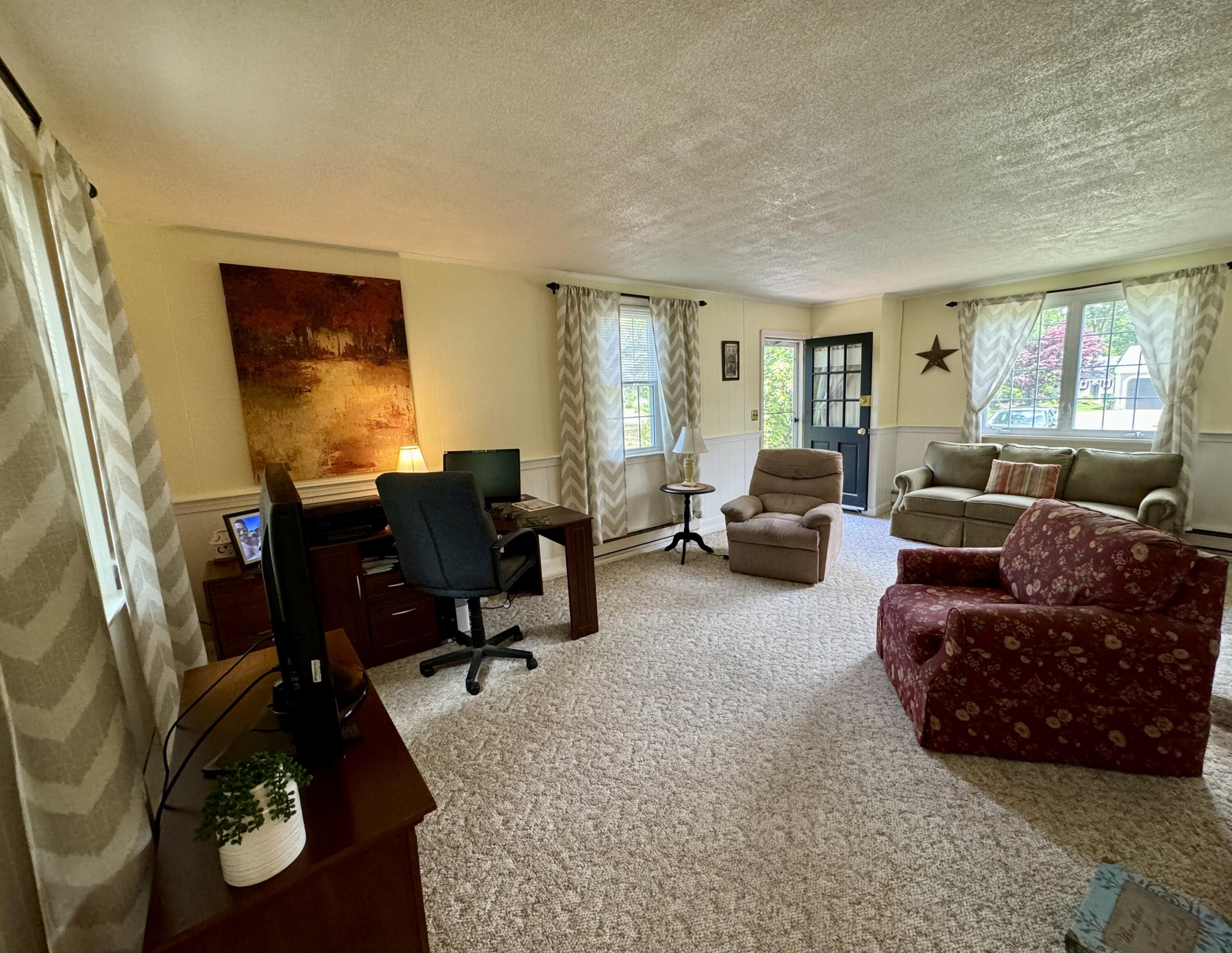 173 Nottingham Drive Centerville, MA 02632 - Photo 17 of 54 a living room with furniture and a flat screen tv with wooden floor