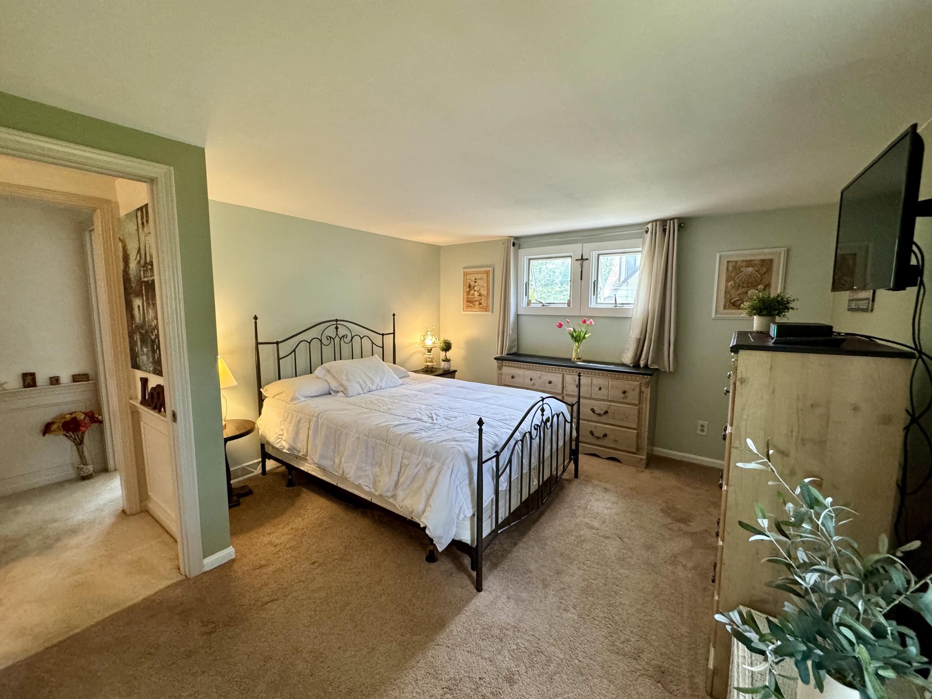 173 Nottingham Drive Centerville, MA 02632 - Photo 23 of 54 a bedroom with a bed flat screen tv and a window