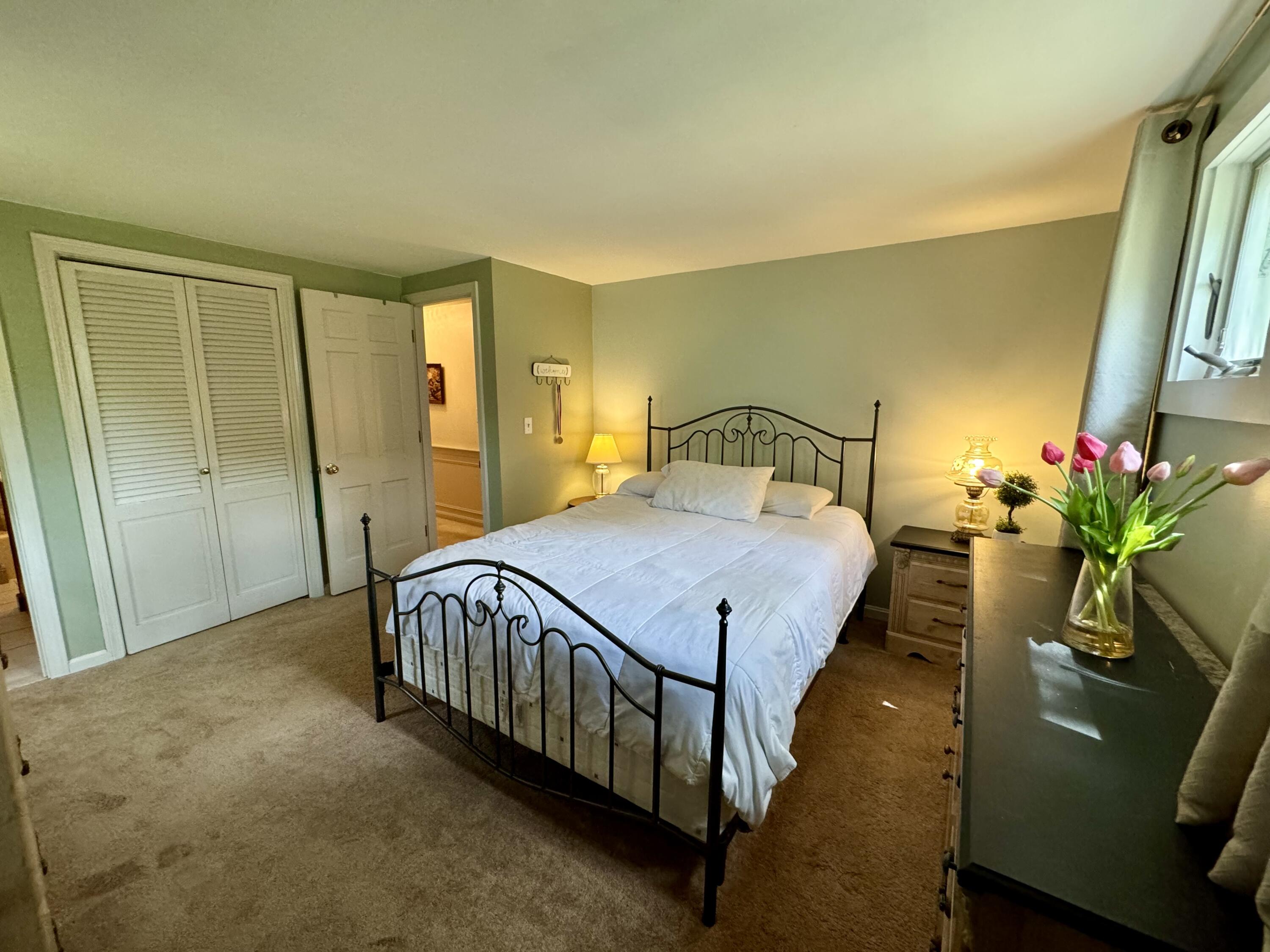 173 Nottingham Drive Centerville, MA 02632 - Photo 24 of 54 a bedroom with a bed window and a potted plant