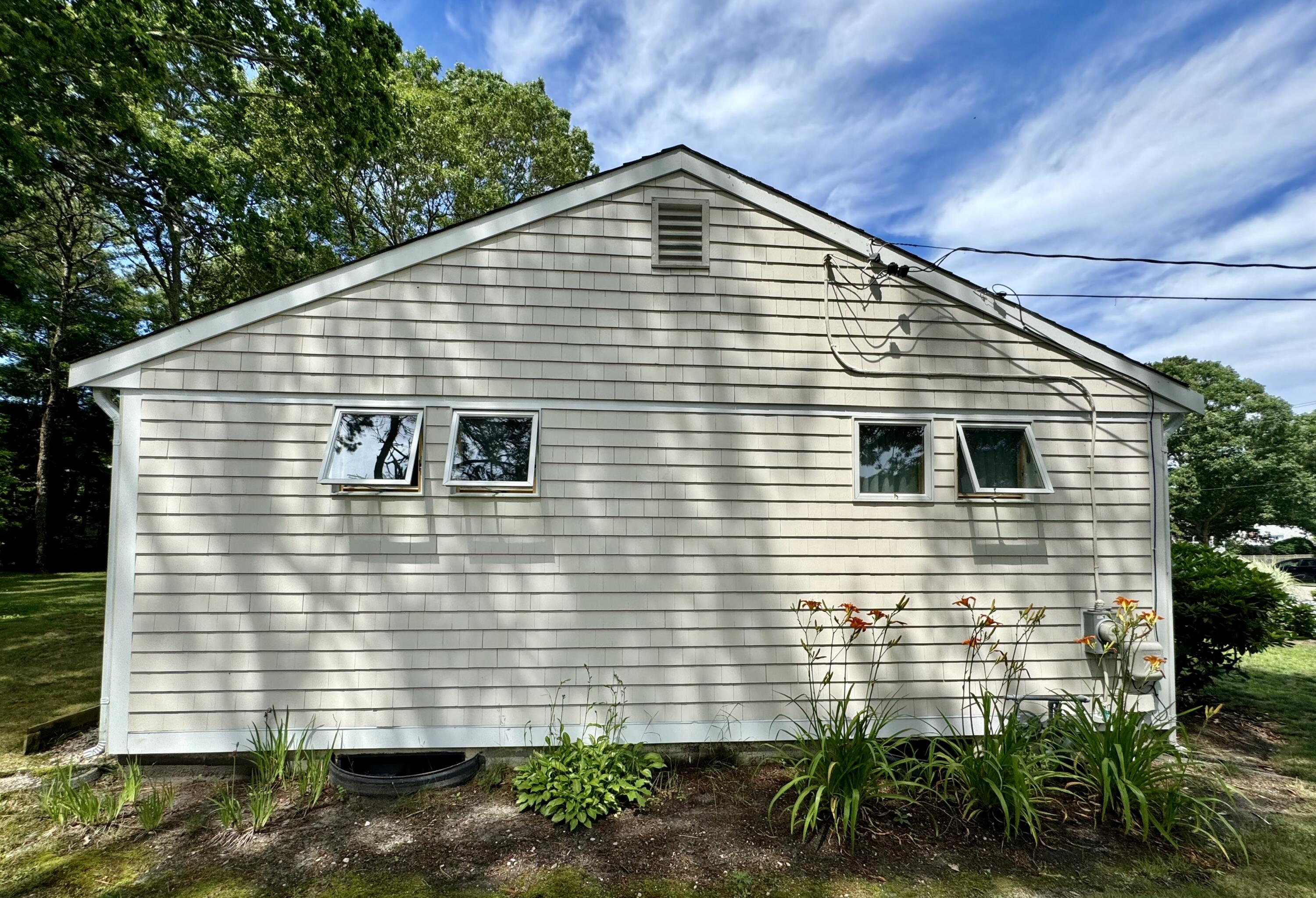 173 Nottingham Drive Centerville, MA 02632 - Photo 37 of 54 a view of a house with a yard and plants