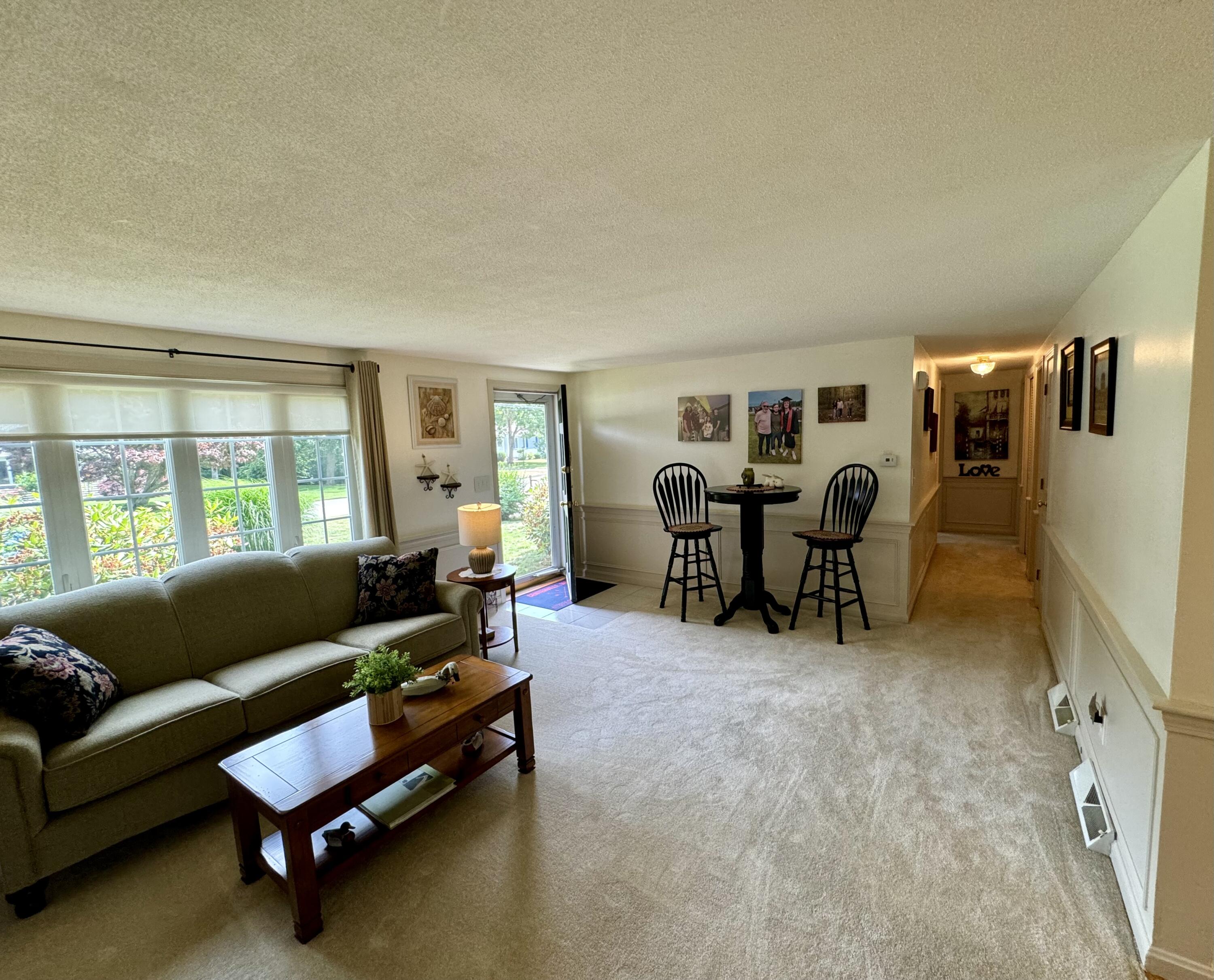 173 Nottingham Drive Centerville, MA 02632 - Photo 7 of 54 a living room with furniture and a large window