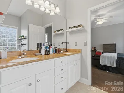 a bathroom with a sink double vanity and a mirror