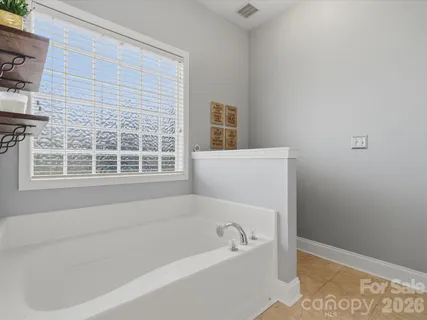 a white bath tub sitting next to a window
