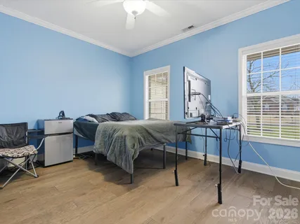 a bed room with a bed and a chair