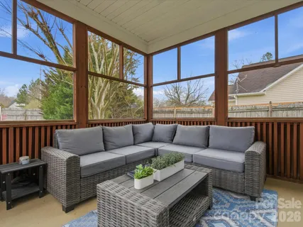 a living room with furniture city view and large windows