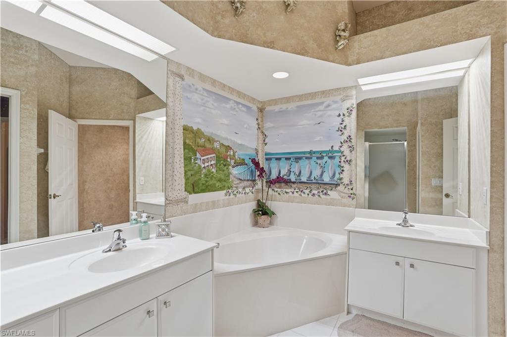 10871 Crooked River Road, Unit 202 Estero, FL 34135 - Photo 24 of 46 a bathroom with a sink double vanity and a mirror