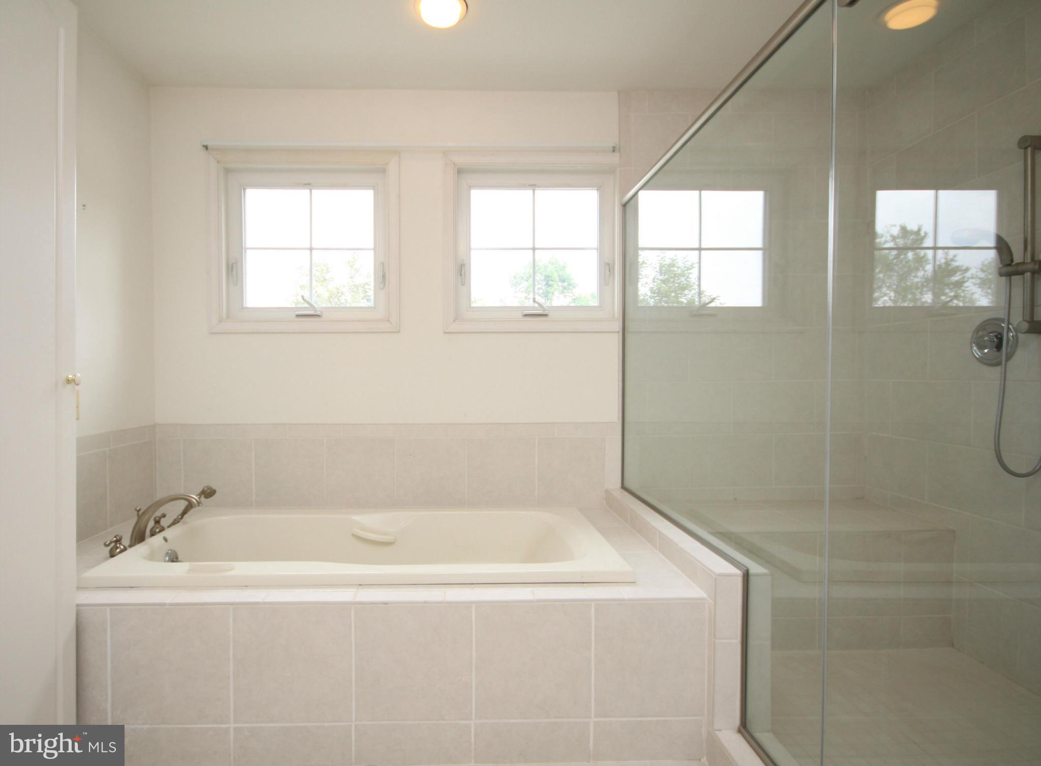 9706 Saxony Road Silver Spring, MD 20910 - Photo 11 of 30 Mstr Bath tub and double shower/sitting area
