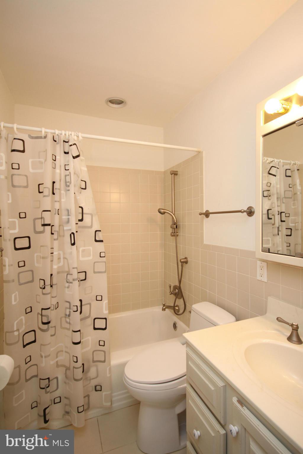 9706 Saxony Road Silver Spring, MD 20910 - Photo 10 of 30 Main Bath,Ceramic tile; stackable Laundry beside