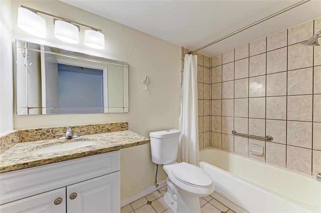 3534 Richwood, Unit 44 Sarasota, FL 34235 - Photo 14 of 26 a bathroom with a granite countertop sink a toilet and shower