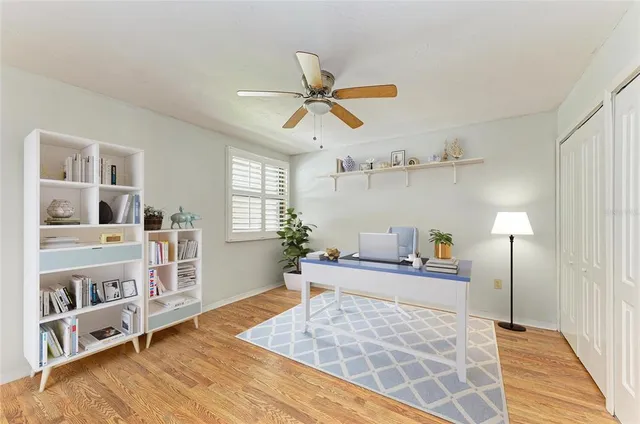 a living room with furniture and a book shelf