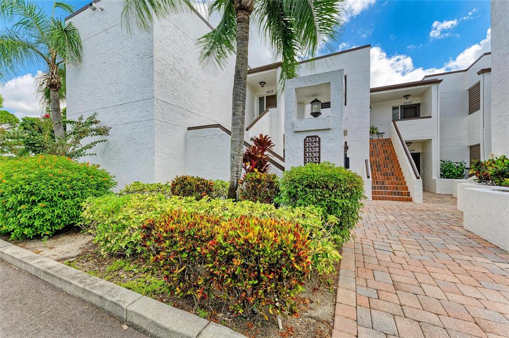 3534 Richwood, Unit 44 Sarasota, FL 34235 - Photo 2 of 26 a front view of a house with a yard