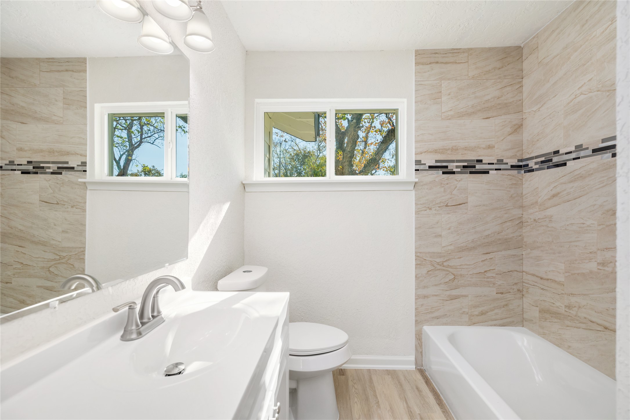5915 Beldart Street Houston, TX 77033 - Photo 11 of 15 a white bath tub sitting next to a white sink