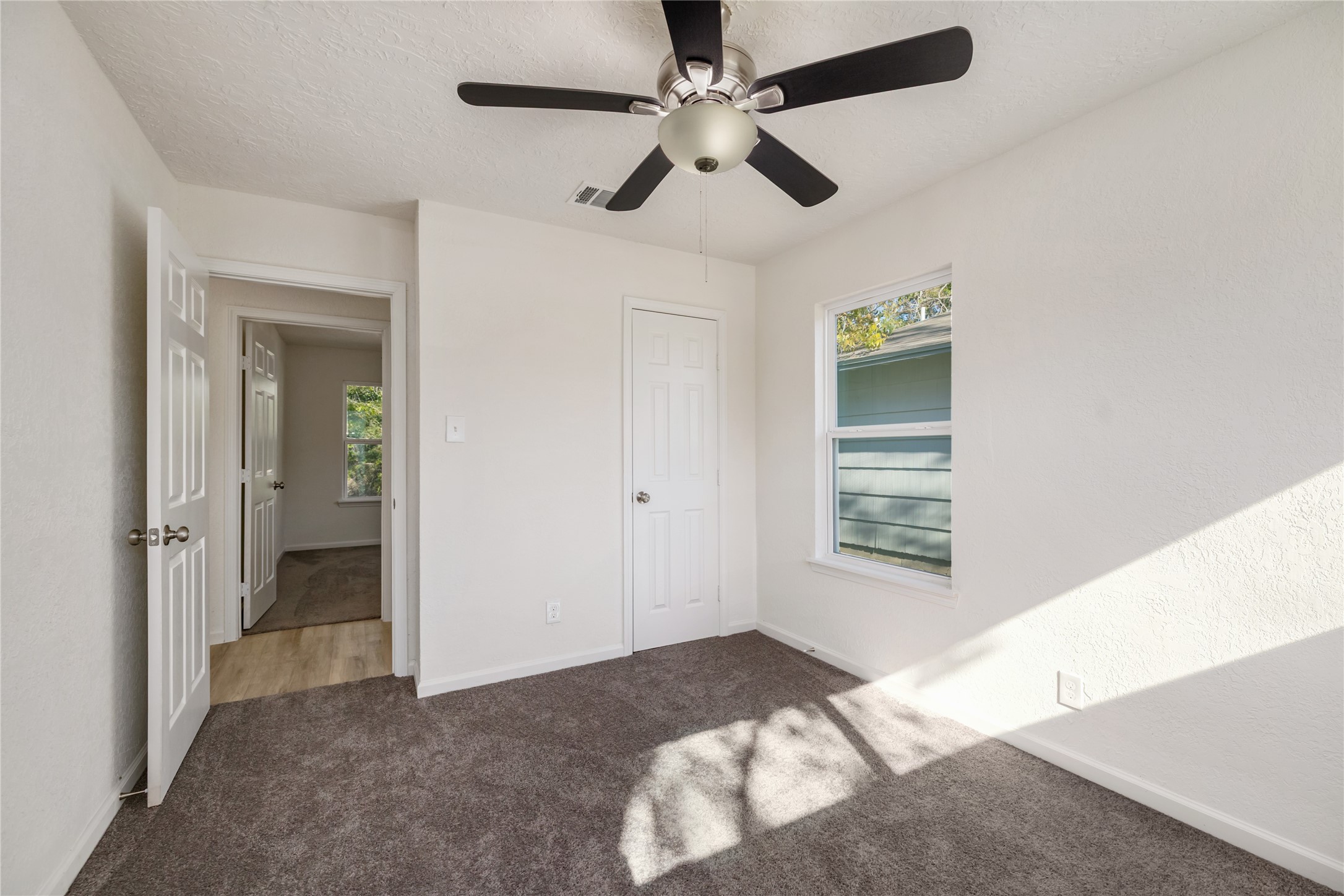 5915 Beldart Street Houston, TX 77033 - Photo 13 of 15 a bedroom with a bed and a chandelier fan