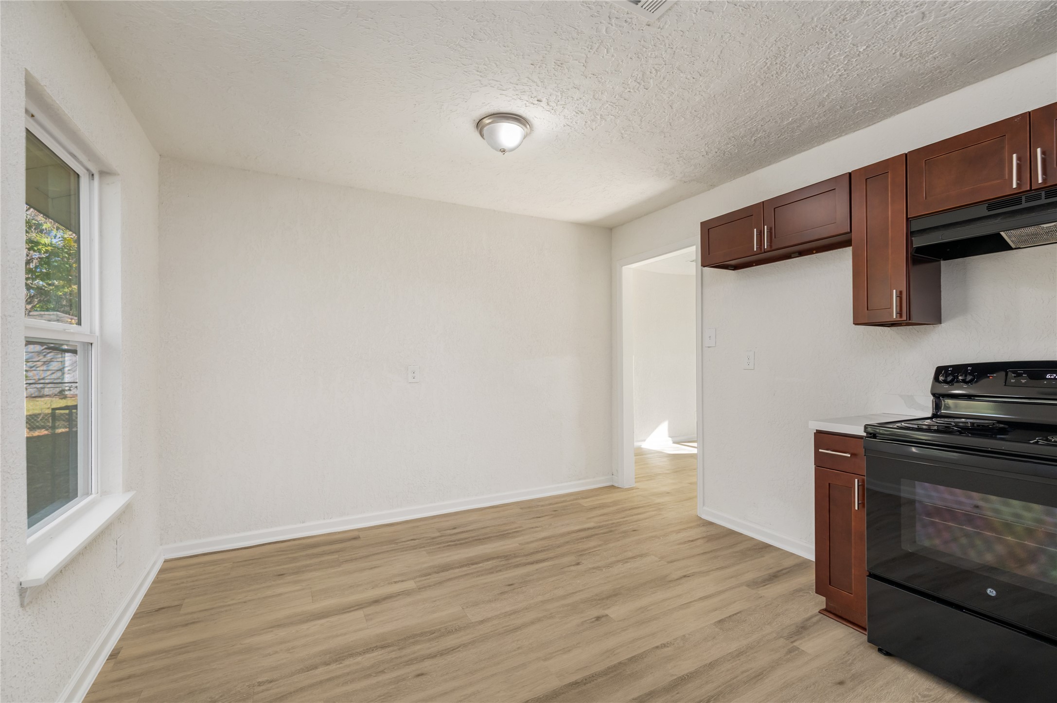 5915 Beldart Street Houston, TX 77033 - Photo 4 of 15 a kitchen with stainless steel appliances a stove and a refrigerator
