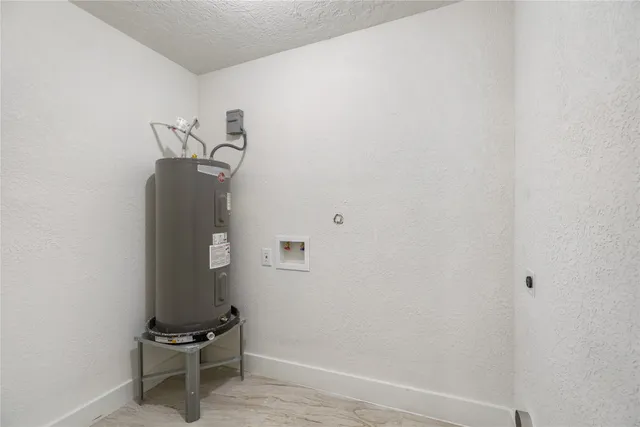 an empty room with windows and ceiling fan