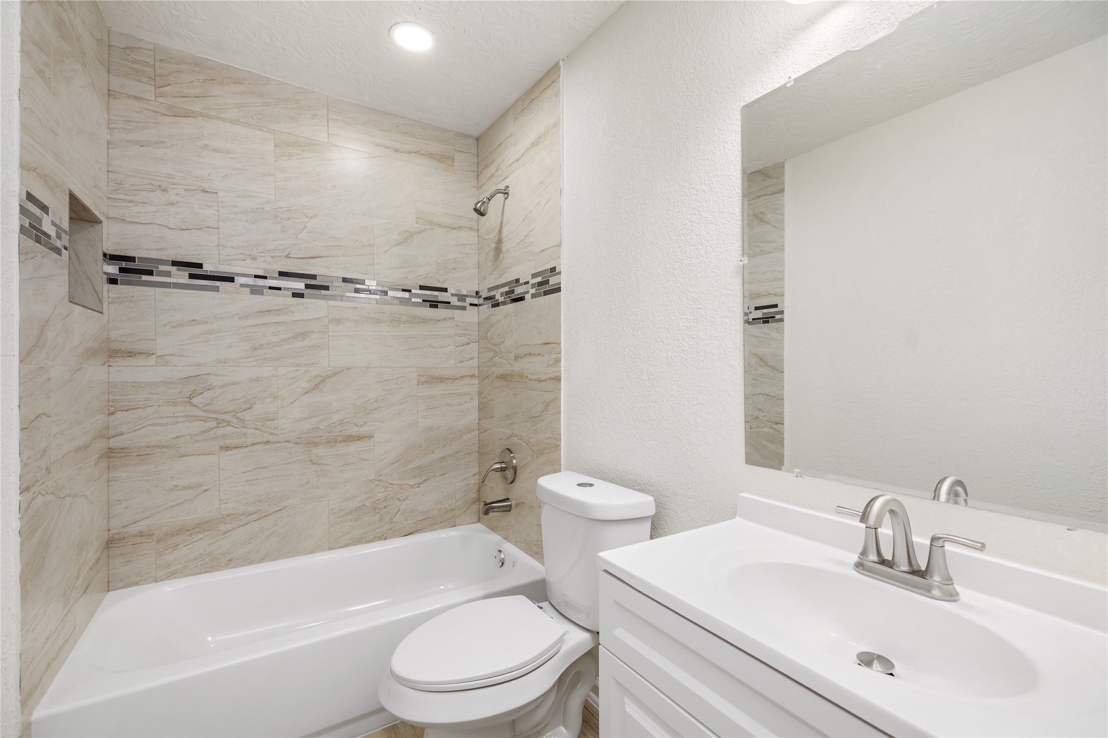 5915 Beldart Street Houston, TX 77033 - Photo 7 of 15 a bathroom with a bathtub shower sink vanity mirror and toilet