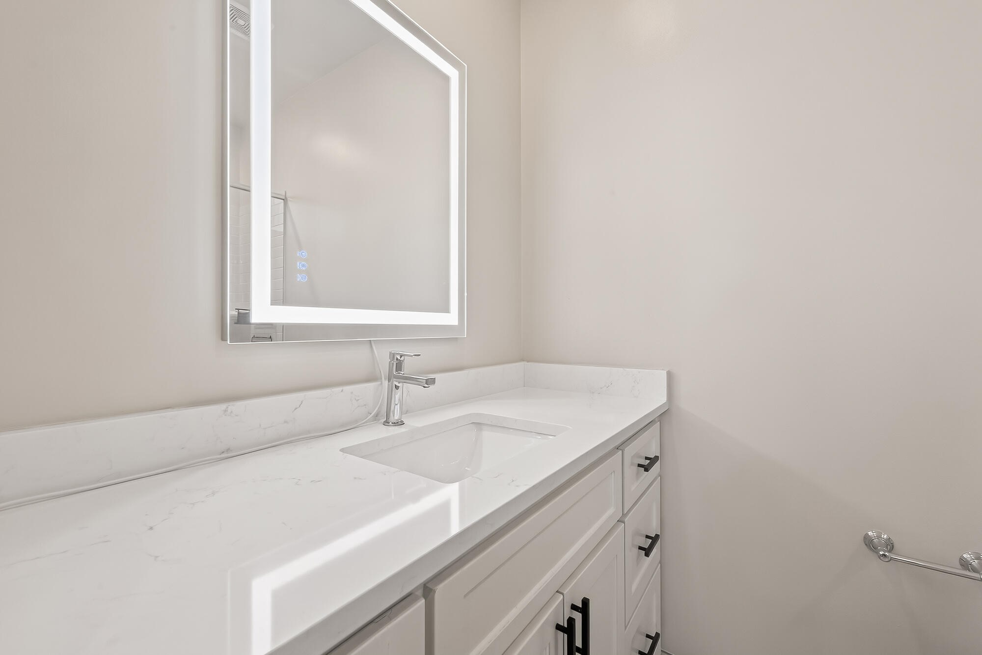 122 Gateway Park Place Spring, TX 77380 - Photo 36 of 44 Half bathroom vanity with quartz countertop, sleek fixtures, and an illuminated mirror for a modern look.