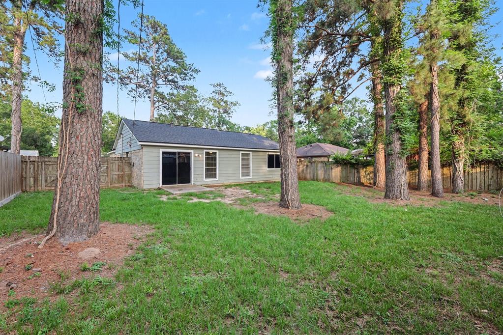 1321 North 7th Street Conroe, TX 77301 - Photo 15 of 17 a front view of a house with garden