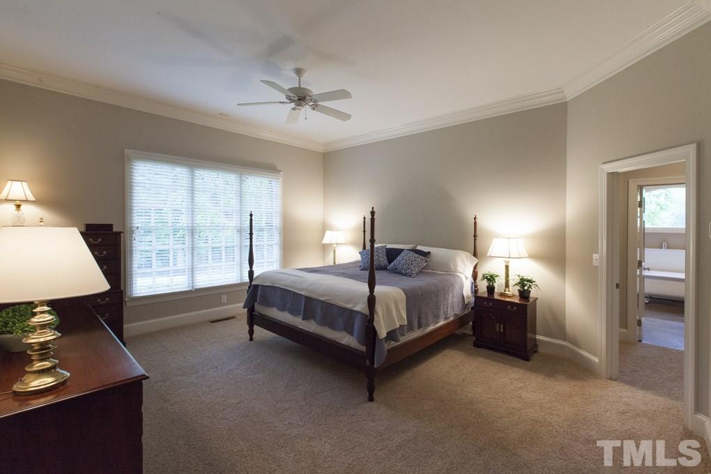 5 Pearse Wynd Road Bahama, NC 27503 - Photo 14 of 25 a spacious bedroom with a bed and a window