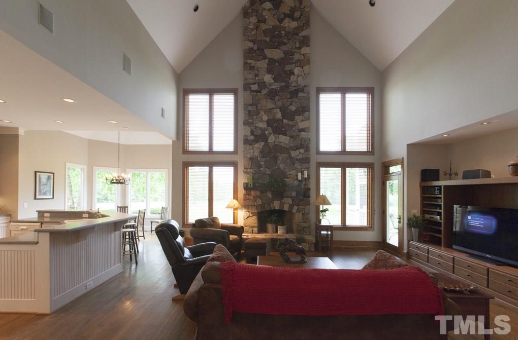 5 Pearse Wynd Road Bahama, NC 27503 - Photo 6 of 25 a living room with furniture a flat screen tv and a fireplace