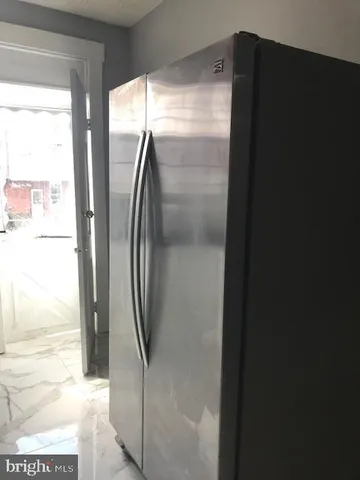 a kitchen with granite countertop wooden cabinets and white appliances