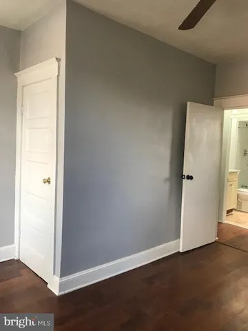 a view of a small space with wooden floor and a window