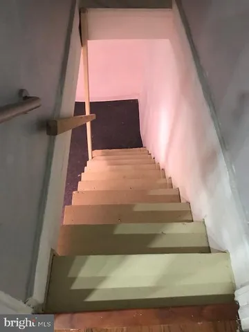 a view of an empty room with a kitchen