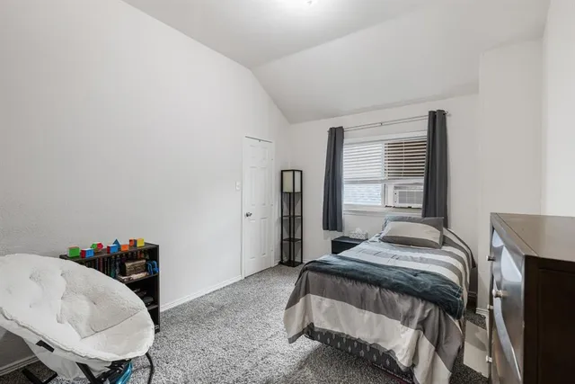 a bedroom with a bed and a table in it