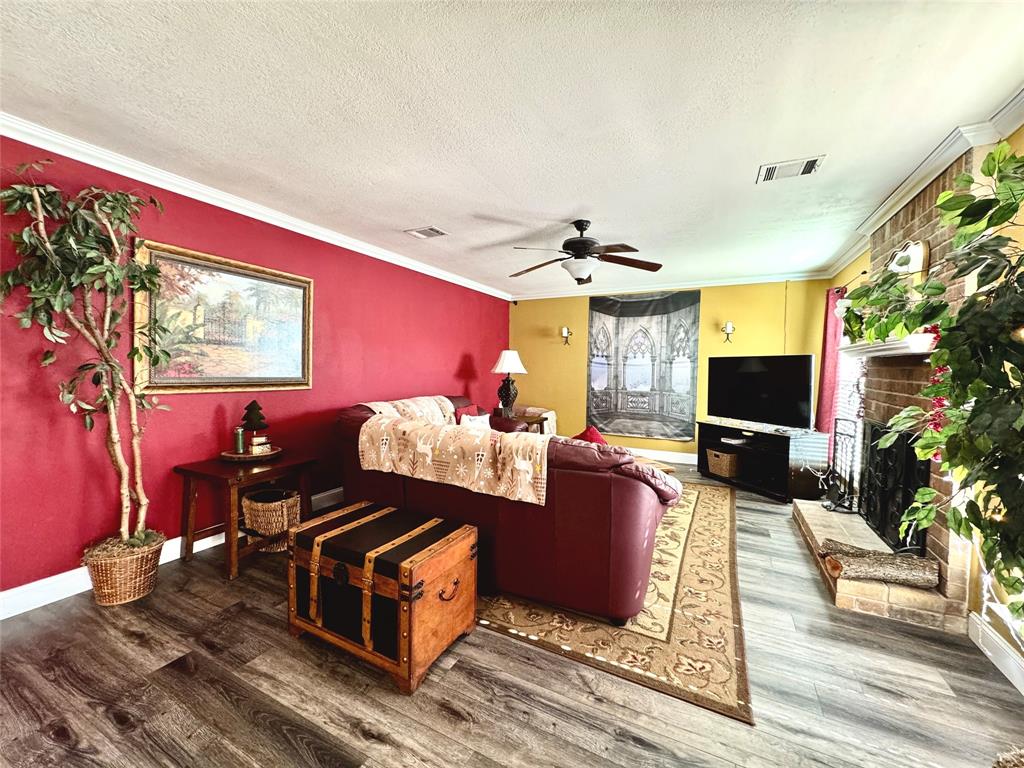 2877 Fenwick Street Grand Prairie, TX 75052 - Photo 4 of 27 a living room with furniture fireplace and flat screen tv