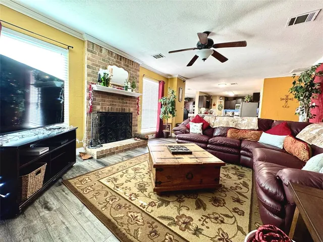 a living room with furniture a flat screen tv and a fireplace