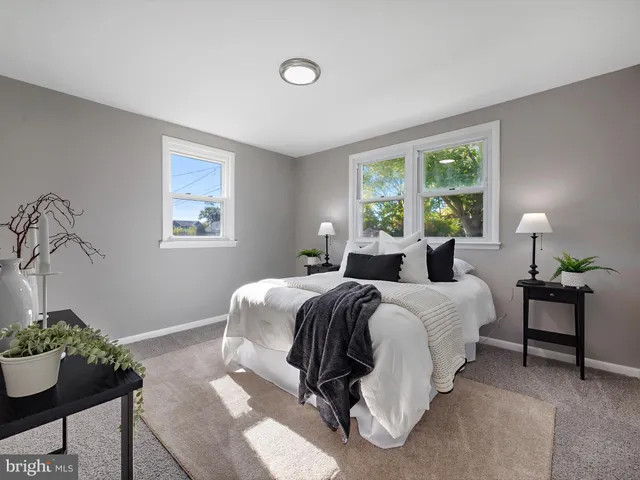 a bed room with a bed and a chair