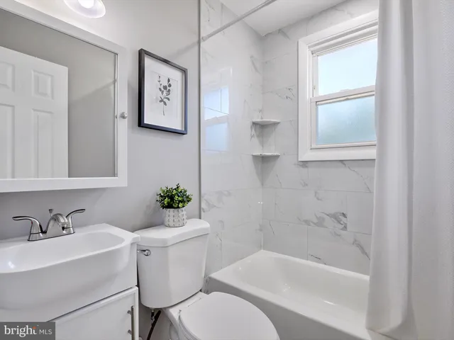a white bath tub sitting next to a white toilet