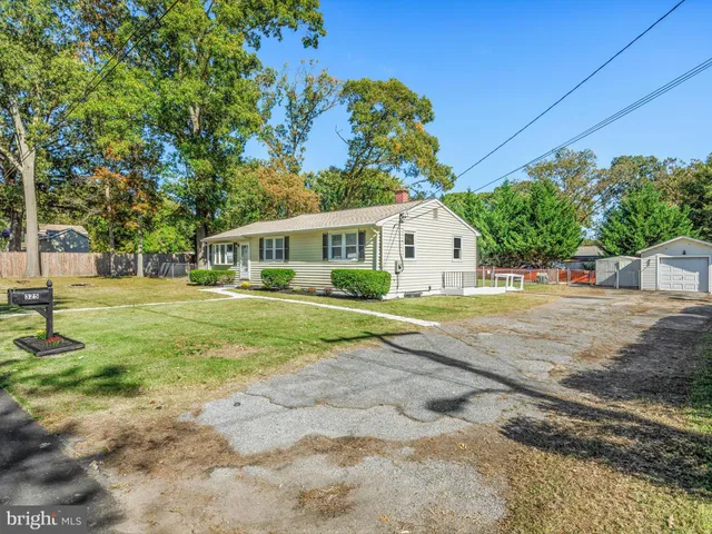 a view of house with outdoor space and garden