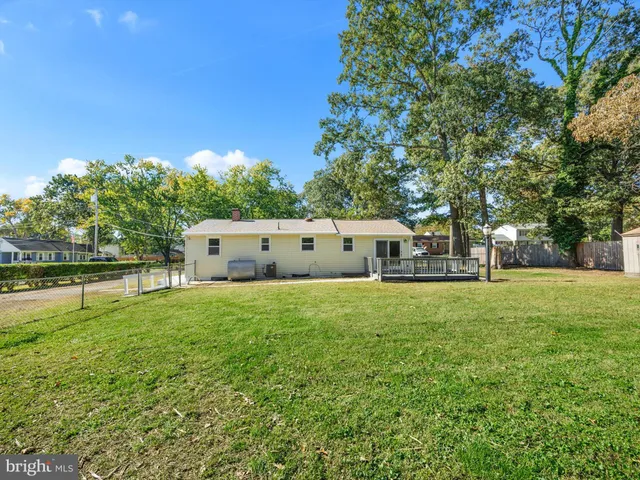 a house view with swimming pool in front of it