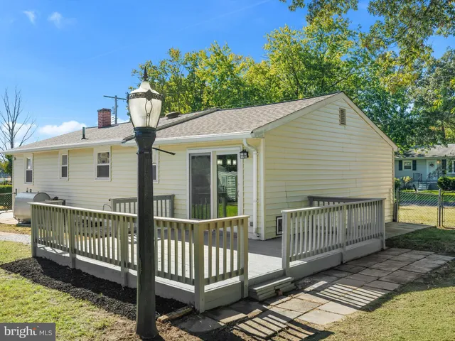 a view of a house with a wooden deck