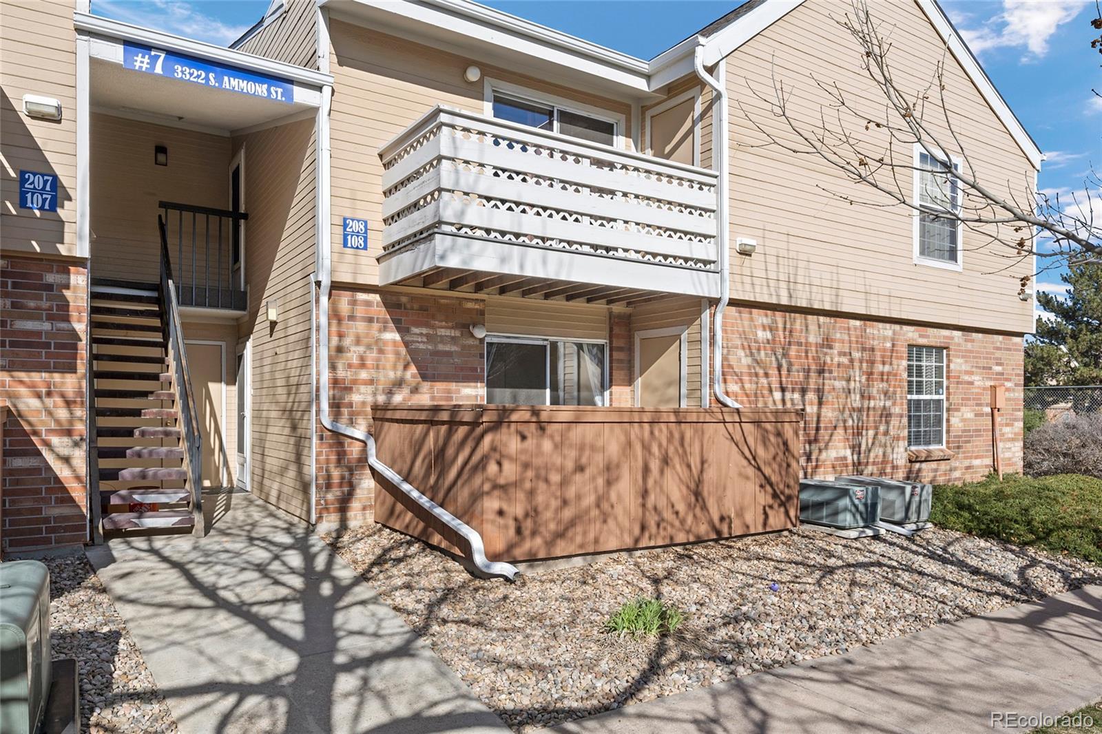 3322 South Ammons Street, Unit 108 Lakewood, CO 80227 - Photo 1 of 21 a view of a house with a wooden door