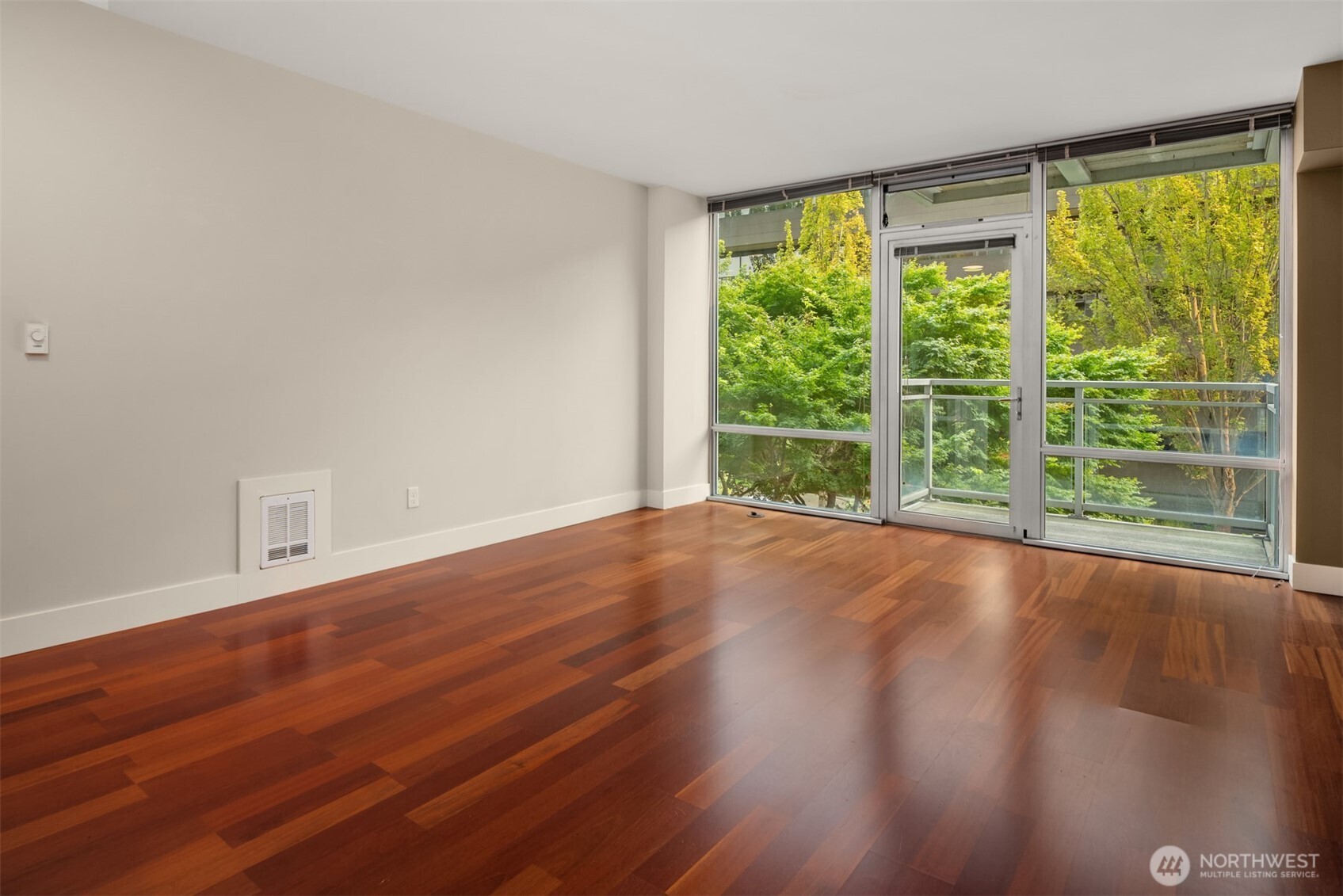 2911 2nd Avenue, Unit 310 Seattle, WA 98121 - Photo 11 of 40 a view of a room with wooden floor and large window