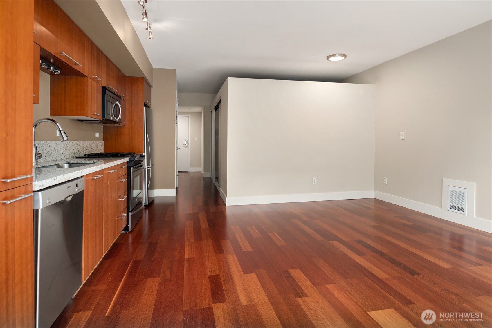 2911 2nd Avenue, Unit 310 Seattle, WA 98121 - Photo 17 of 40 a view of a kitchen with wooden floor and electronic appliances