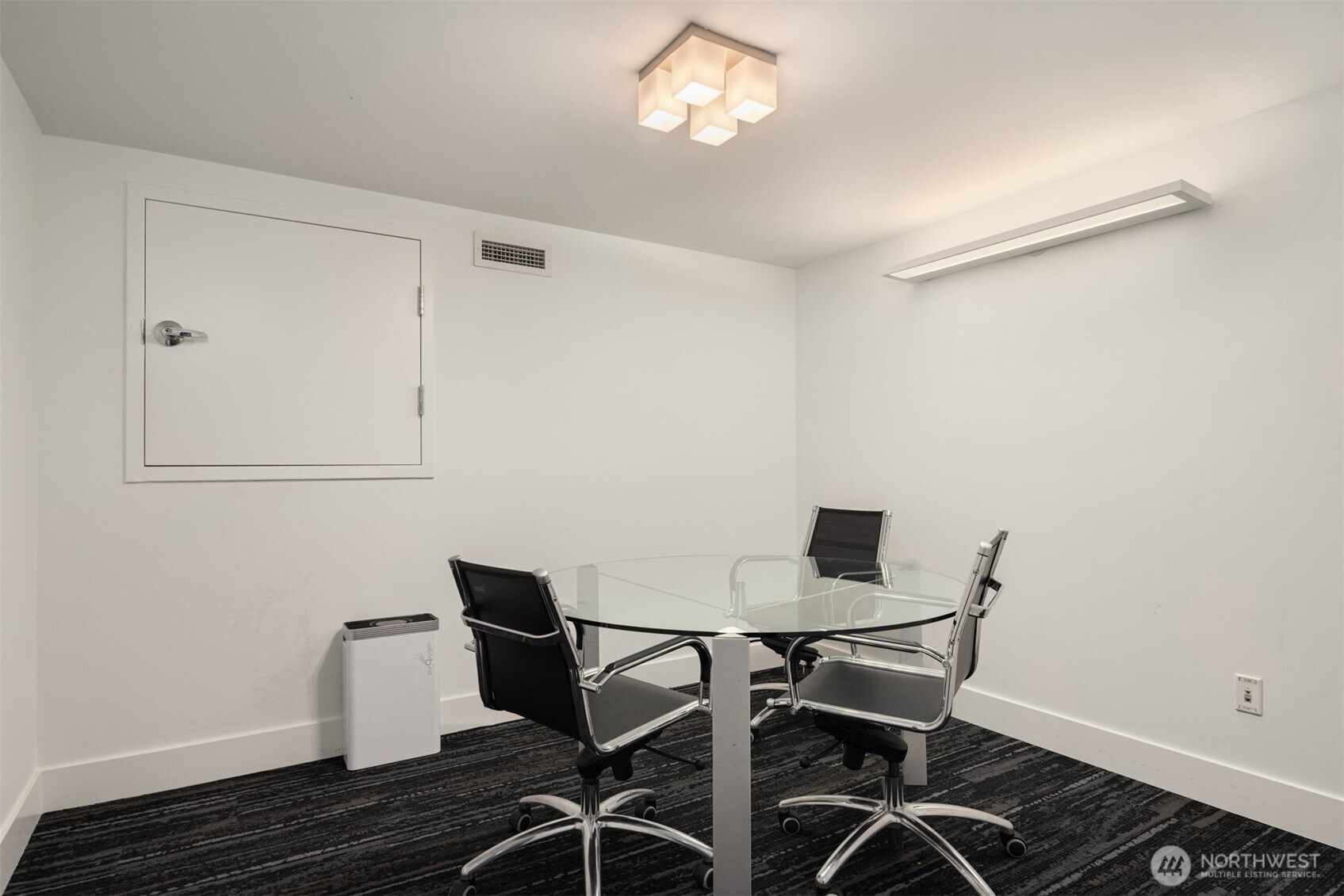 2911 2nd Avenue, Unit 310 Seattle, WA 98121 - Photo 25 of 40 a view of a workspace with furniture and wooden floor