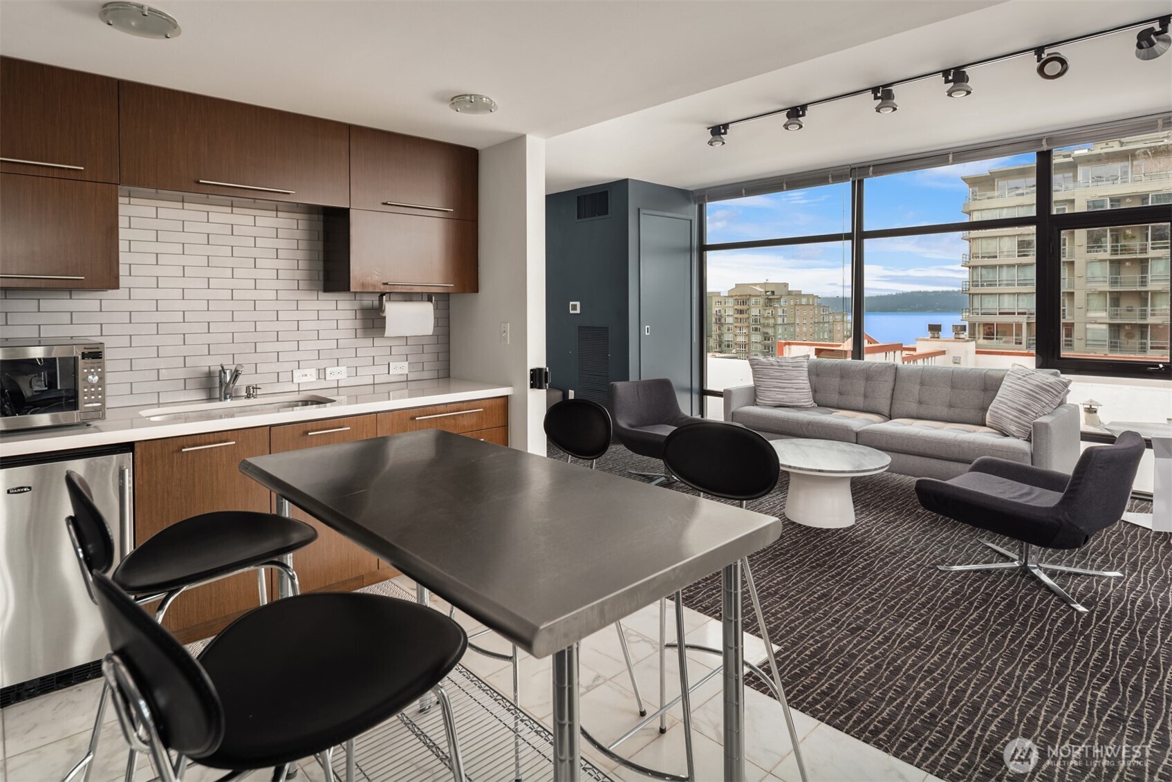 2911 2nd Avenue, Unit 310 Seattle, WA 98121 - Photo 28 of 40 a kitchen with a table chairs stove and granite counter top
