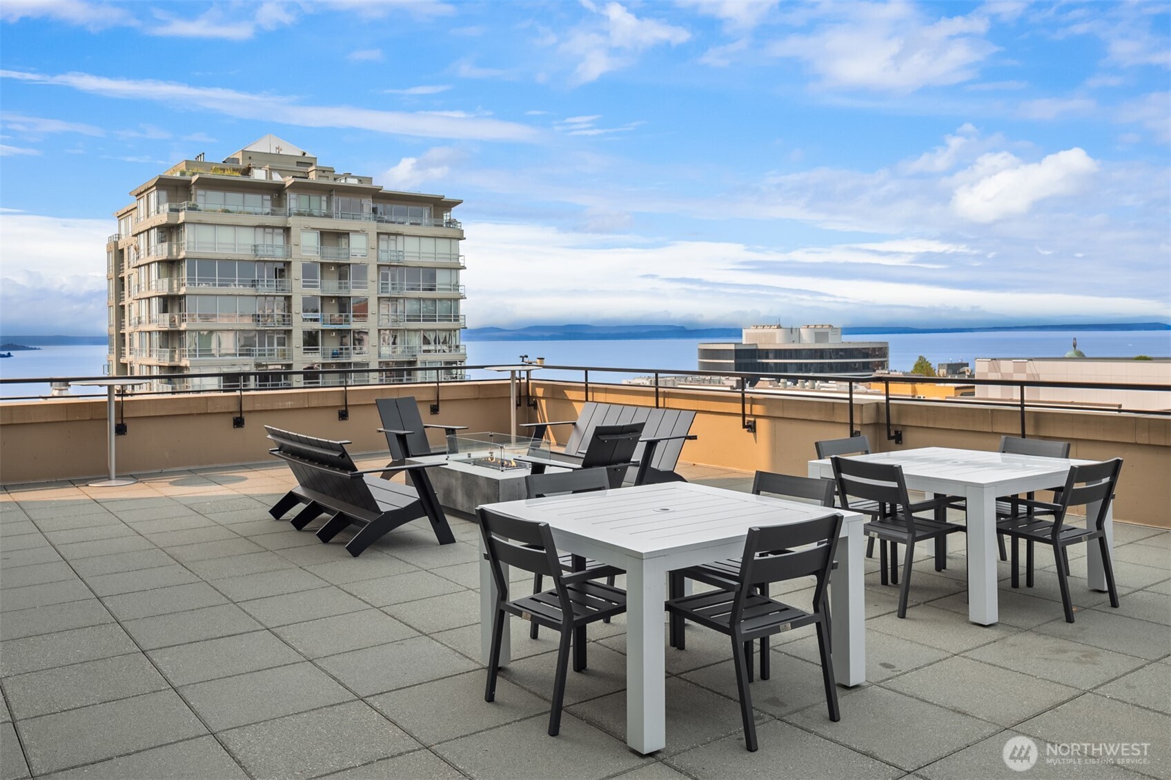 2911 2nd Avenue, Unit 310 Seattle, WA 98121 - Photo 29 of 40 a roof deck with outdoor seating and city view