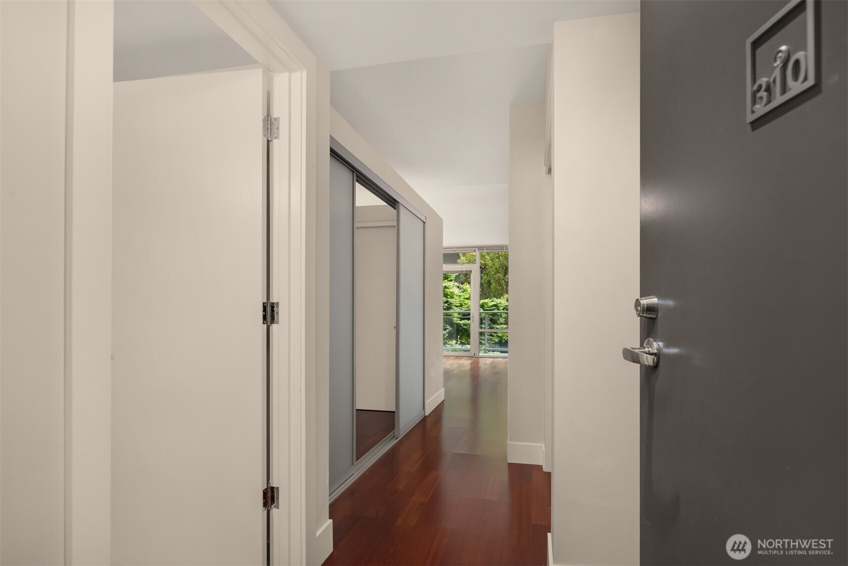 2911 2nd Avenue, Unit 310 Seattle, WA 98121 - Photo 3 of 40 a view of a hallway with wooden floor
