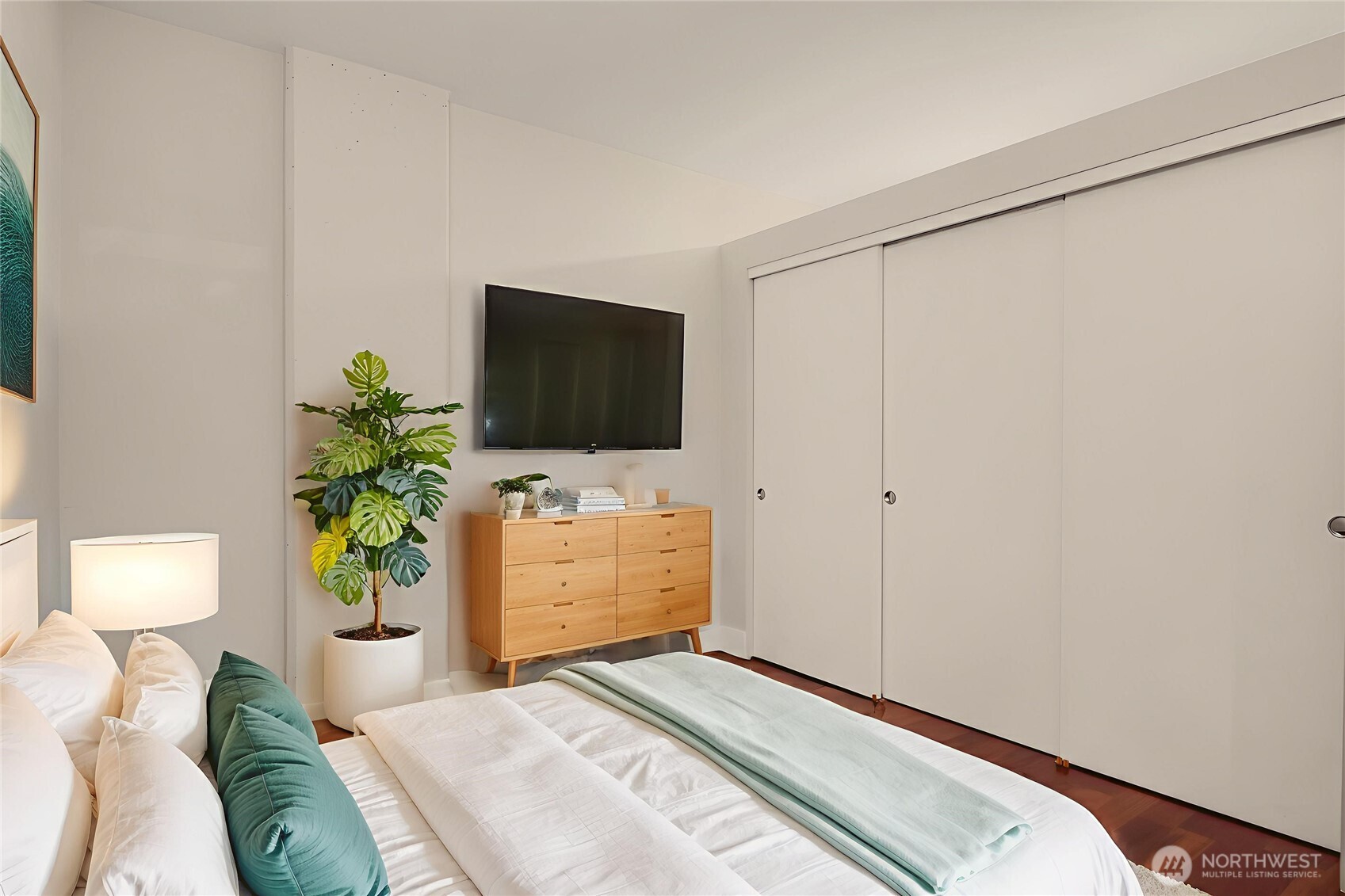 2911 2nd Avenue, Unit 310 Seattle, WA 98121 - Photo 7 of 40 a bedroom with a bed and a flat screen tv