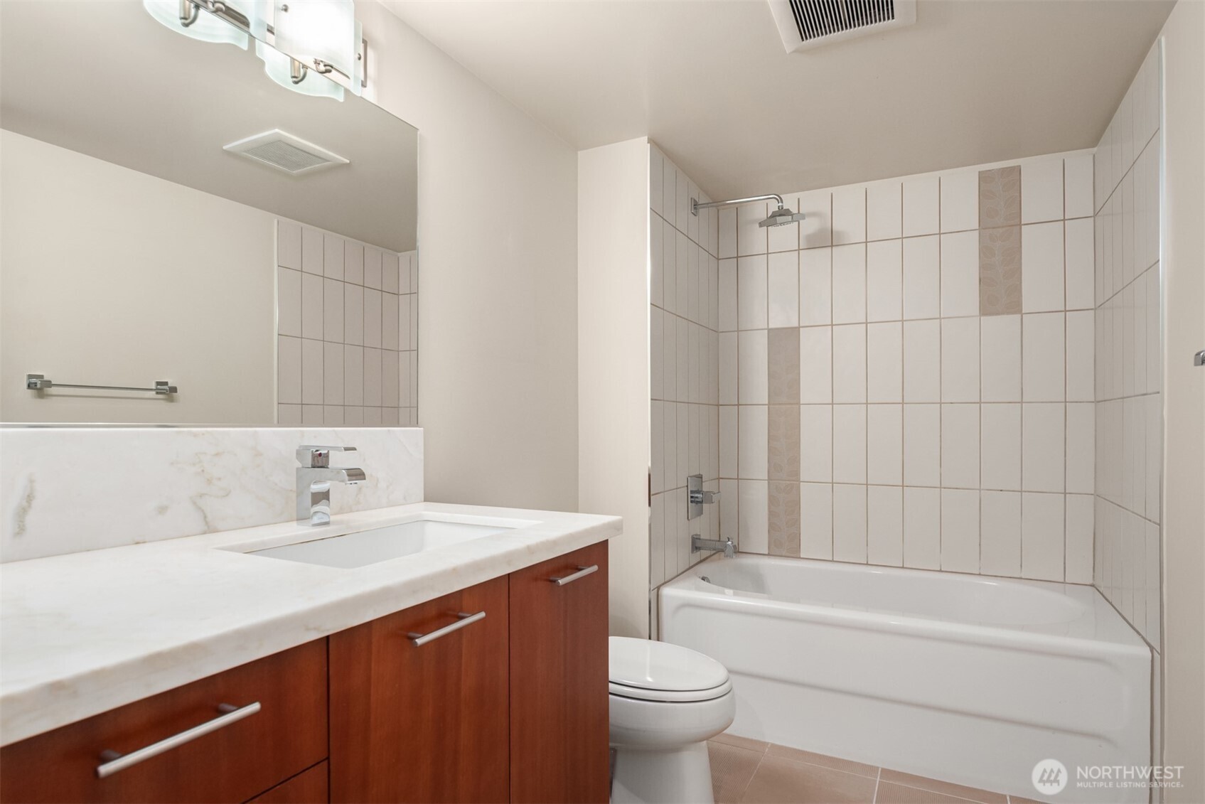 2911 2nd Avenue, Unit 310 Seattle, WA 98121 - Photo 10 of 40 a bathroom with a bathtub a sink a toilet and a mirror