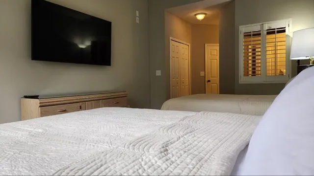a bedroom with a bed and a flat screen tv