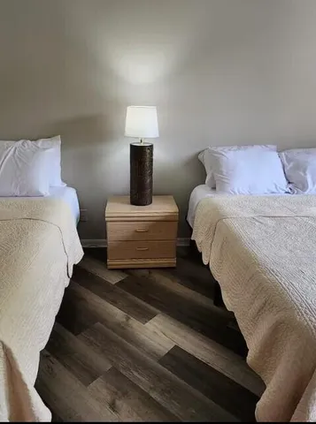 a bedroom with bed and a night stand