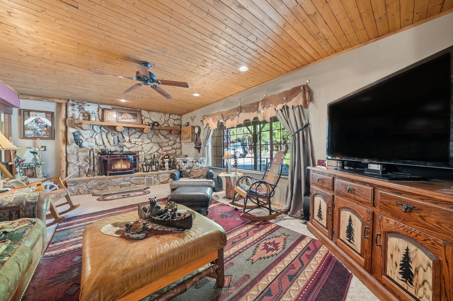 23140 Shake Ridge Road Volcano, CA 95689 - Photo 13 of 81 a living room with furniture and a flat screen tv