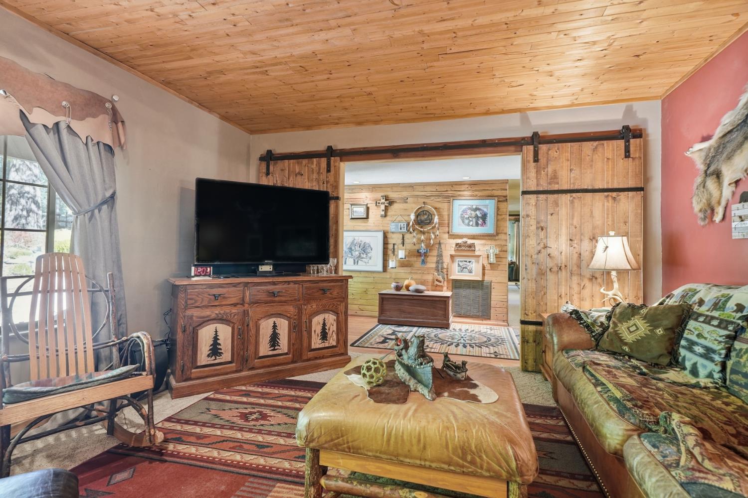 23140 Shake Ridge Road Volcano, CA 95689 - Photo 15 of 81 a living room with furniture and a flat screen tv