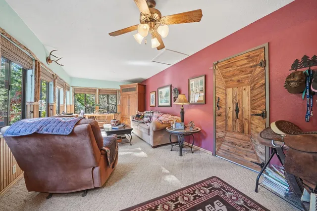 a dining room with wooden floor a chandelier a wooden table and chairs